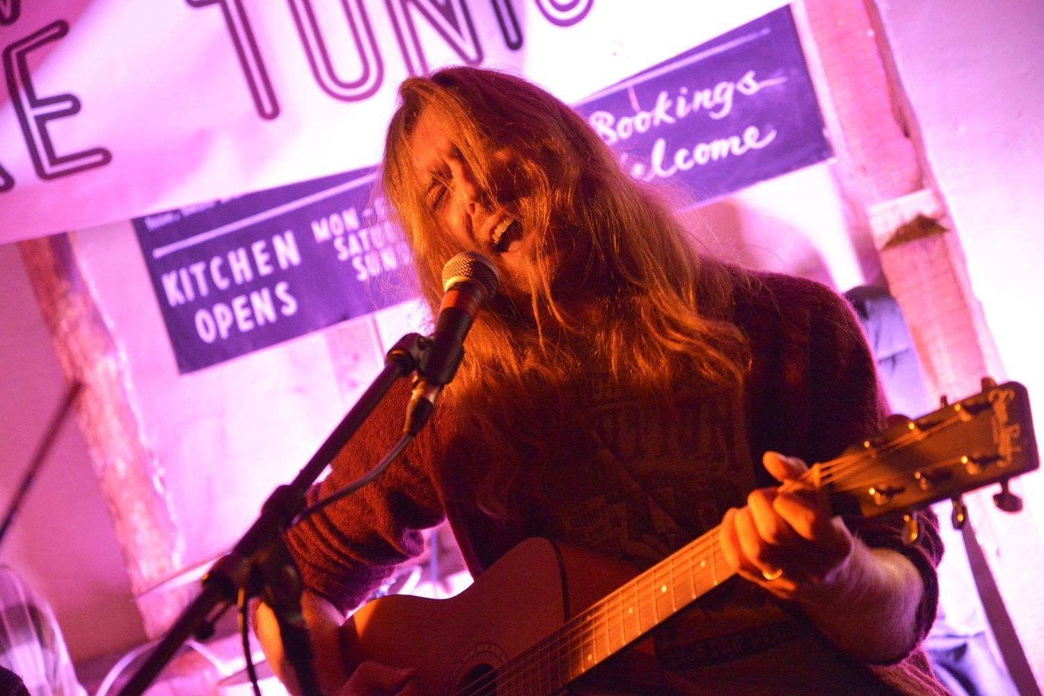 Jon performing live with an acoustic guitar